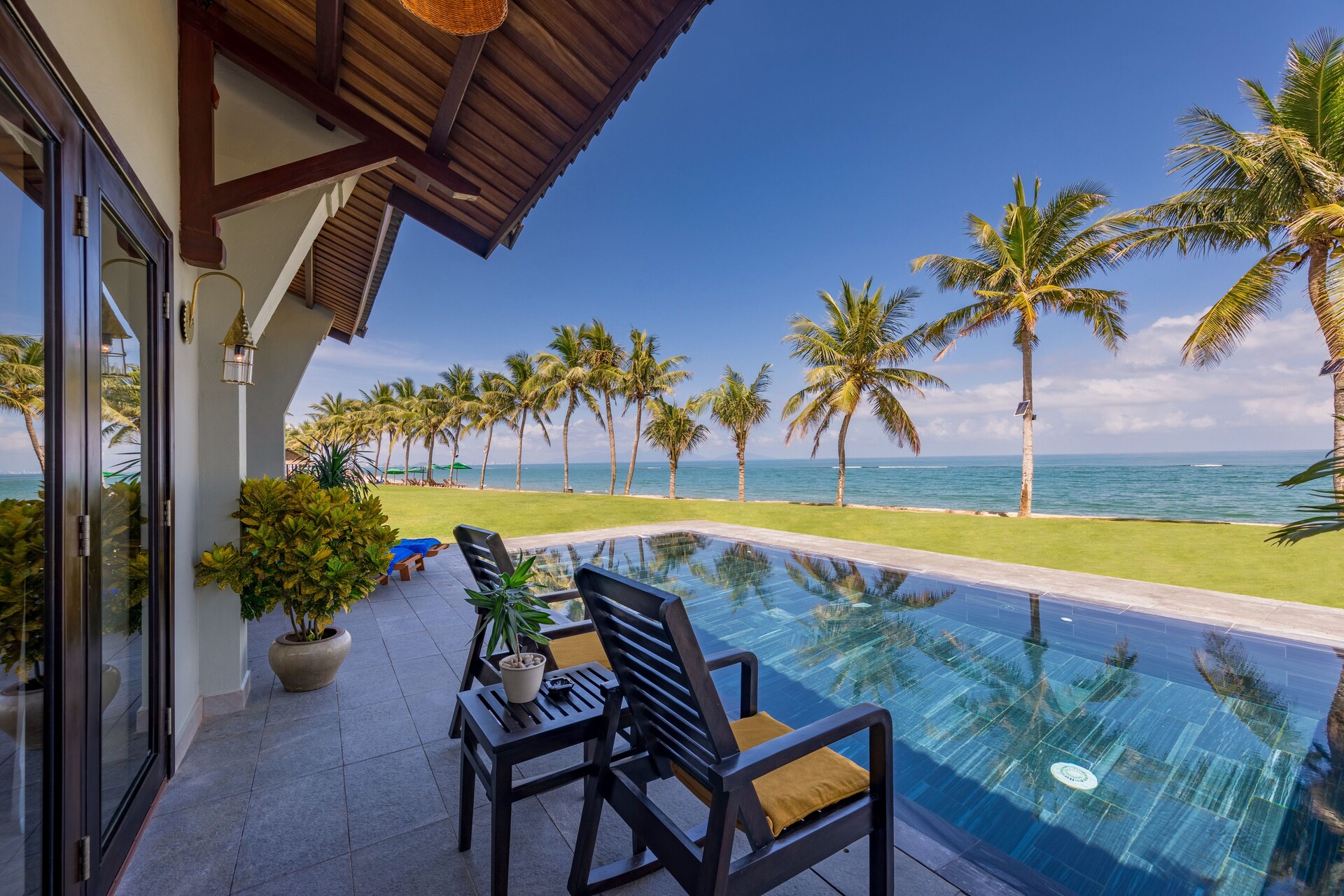 Balcony seating with ocean view at Palm Garden
