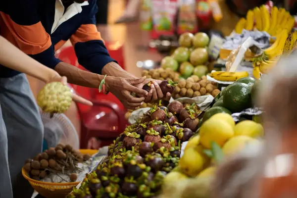 Traveler shopping for tropical fruit at a market