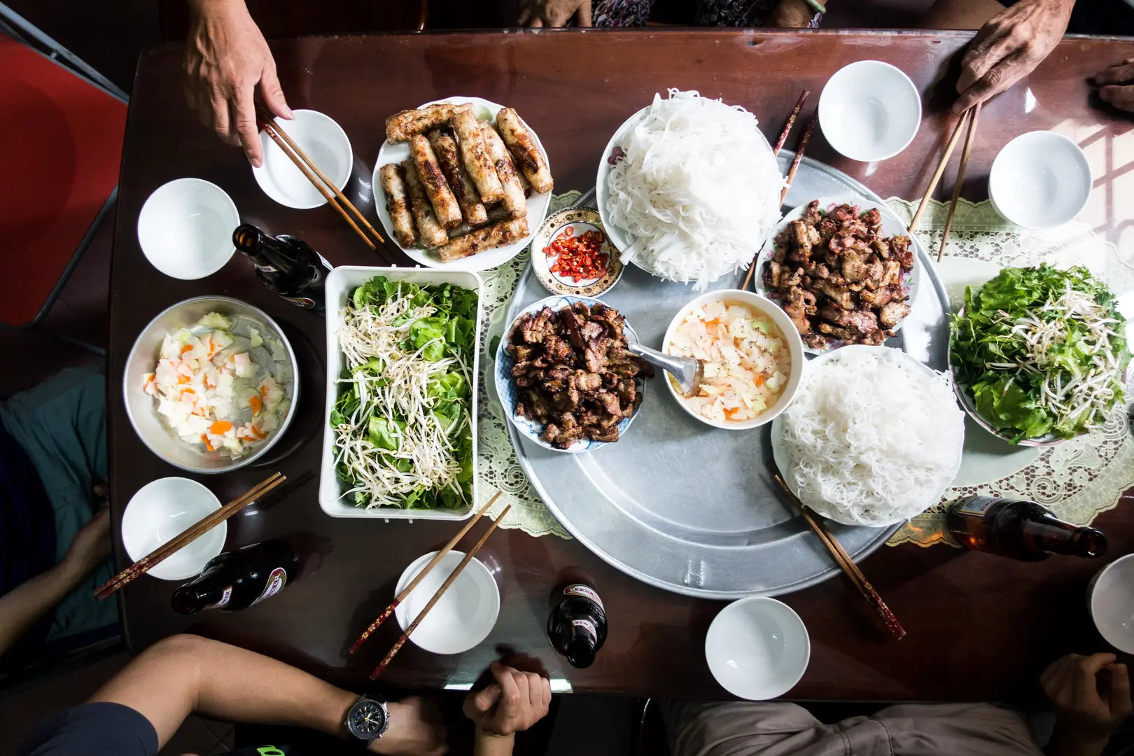 Family feasting on Vietnamese traditional food