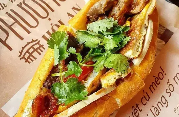 Banh Mi Phuong counter stacked with fresh baguettes