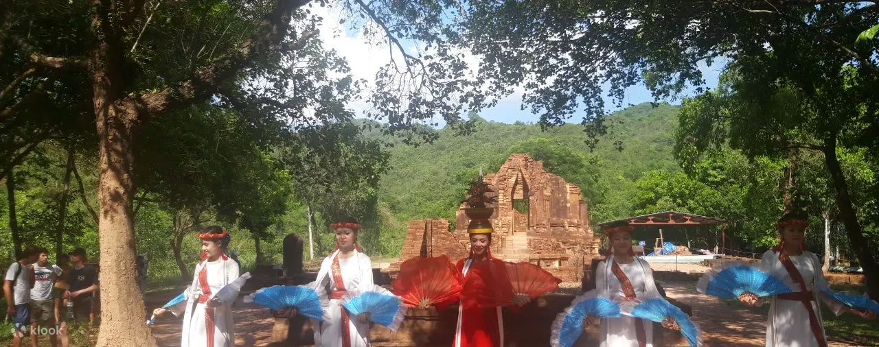 Guide explaining Mỹ Sơn carvings to visitors