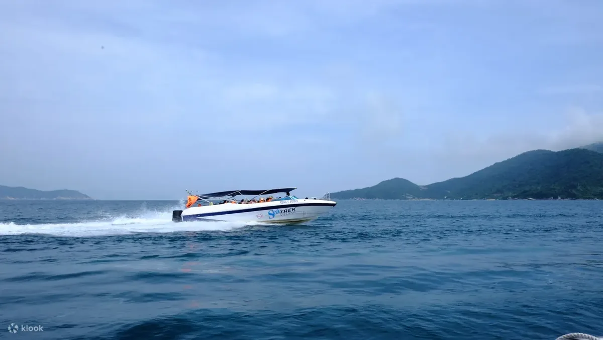 Guests wearing sea-walk helmets surrounded by fish at Cham Islands