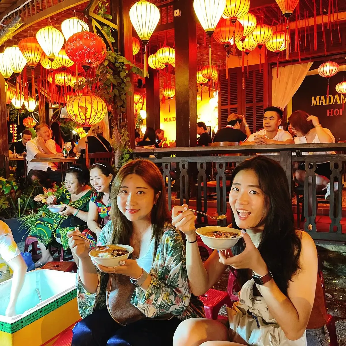 Group photo with áo dài riders after the food tour