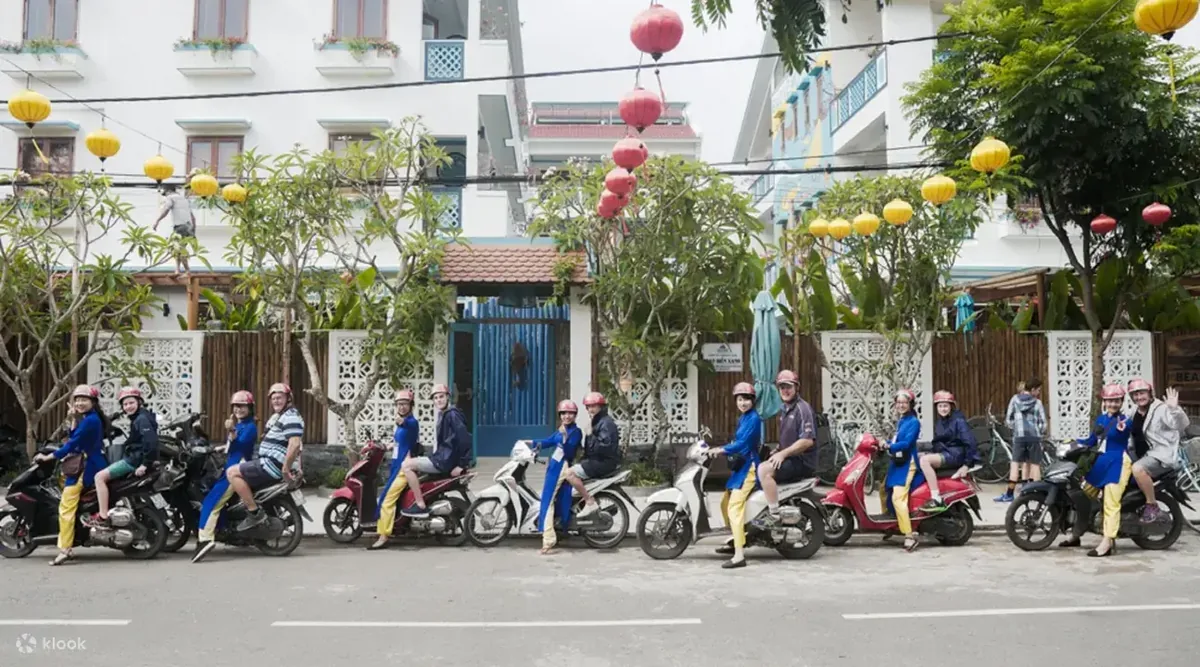 Áo dài riders guiding travelers through Hội An by scooter
