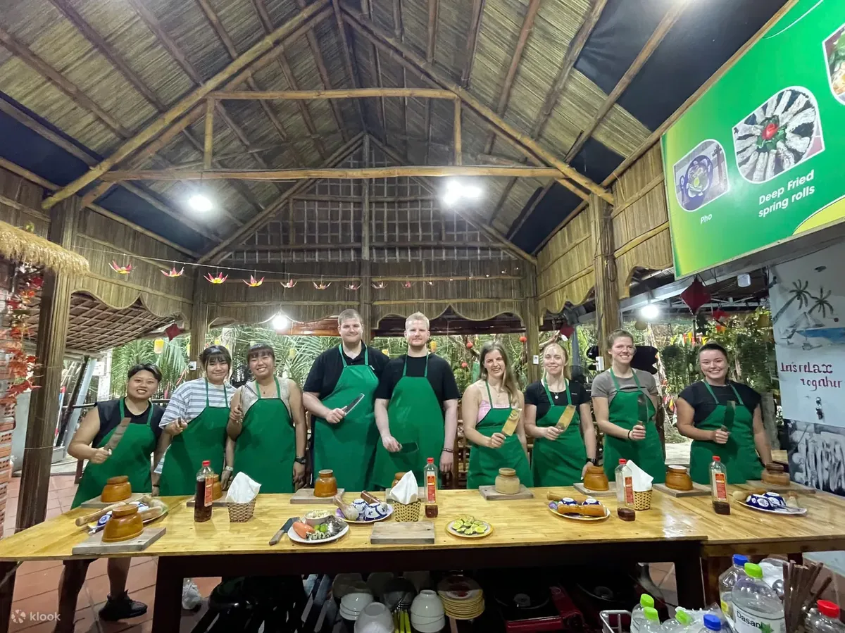 Guests sautéing herbs during a Vietnamese cooking class near Bay Mau Coconut Forest