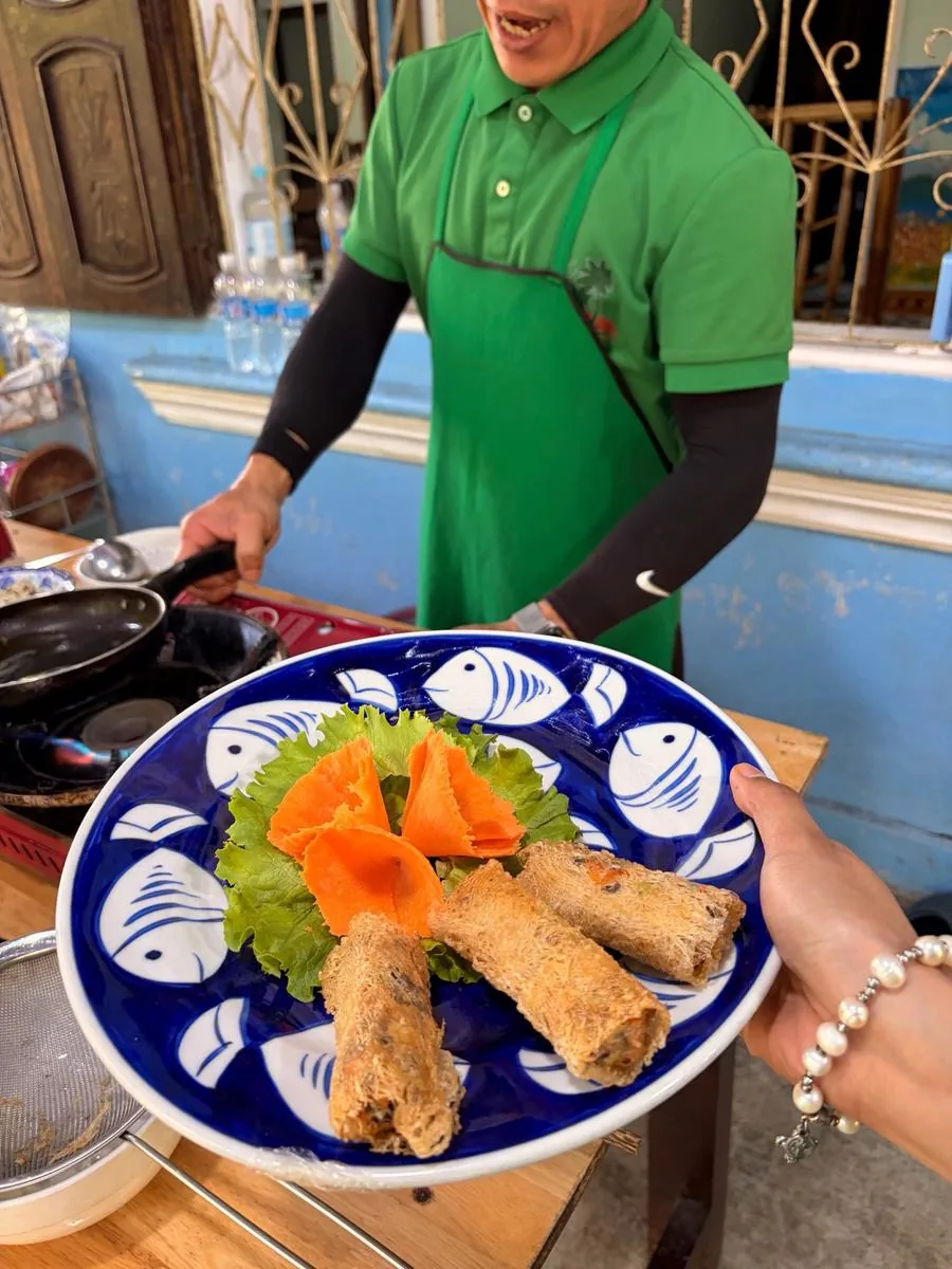 Instructor guiding a guest at the stove